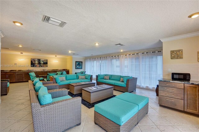 1775 N Andrews Sq Unit 104W, Fort Lauderdale, FL 33311 - living room with ornamental molding, a textured ceiling, light tile patterned floors, and recessed lighting
