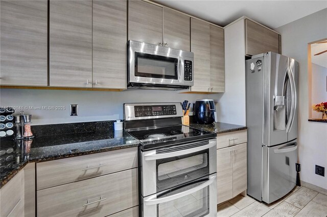 1775 N Andrews Sq Unit 104W, Fort Lauderdale, FL 33311 - kitchen featuring stainless steel appliances, dark stone counters, and modern cabinets