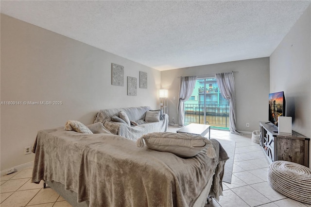 1775 N Andrews Sq Unit 104W, Fort Lauderdale, FL 33311 - bedroom featuring access to outside, light tile patterned floors, and a textured ceiling
