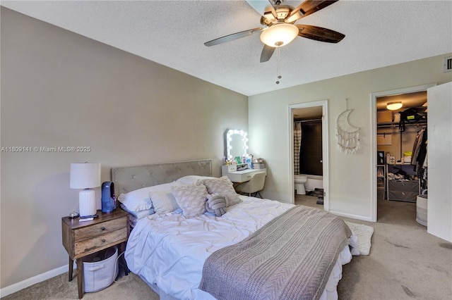 1775 N Andrews Sq Unit 104W, Fort Lauderdale, FL 33311 - bedroom with a spacious closet, carpet flooring, a closet, a textured ceiling, and connected bathroom