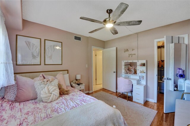 1775 N Andrews Sq Unit 104W, Fort Lauderdale, FL 33311 - bedroom with light wood finished floors, a walk in closet, ceiling fan, and a closet
