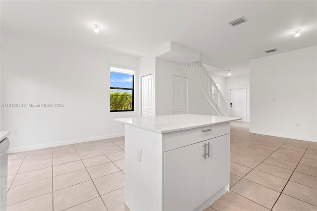 28581 SW 132nd Ct, Homestead, FL 33033 - kitchen with light tile patterned floors, light countertops, a kitchen island, baseboards, and dishwasher