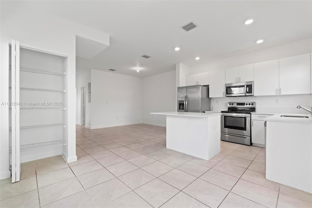 28581 SW 132nd Ct, Homestead, FL 33033 - kitchen with appliances with stainless steel finishes, a sink, a center island, recessed lighting, and light countertops