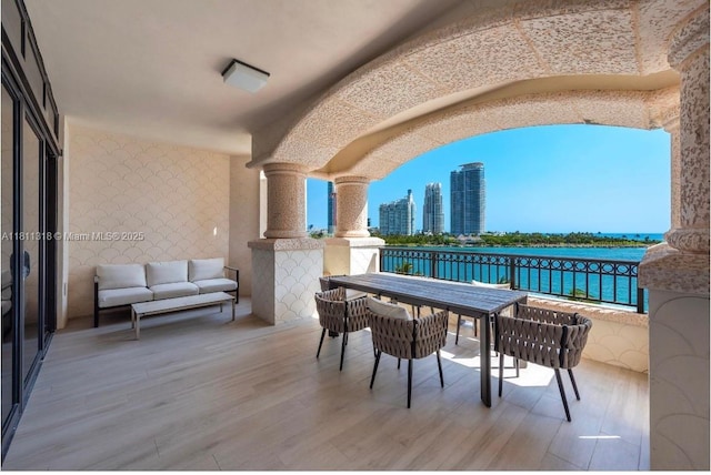 7055 Fisher Island Dr Unit 7055, Miami Beach, FL 33109 - view of patio / terrace with a balcony, a view of city, and a water view