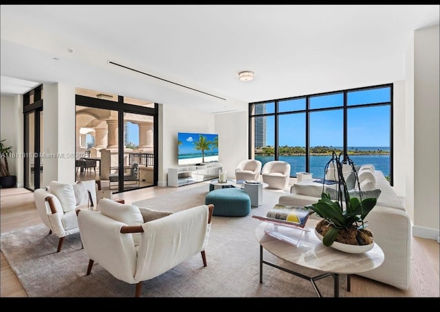 7055 Fisher Island Dr Unit 7055, Miami Beach, FL 33109 - living room featuring wood finished floors, plenty of natural light, and floor to ceiling windows