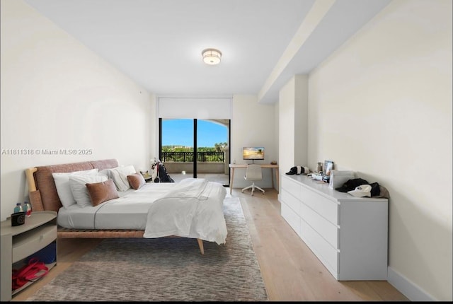 7055 Fisher Island Dr Unit 7055, Miami Beach, FL 33109 - bedroom featuring light wood-style flooring, access to outside, and expansive windows
