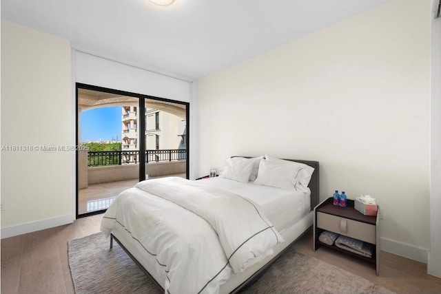 7055 Fisher Island Dr Unit 7055, Miami Beach, FL 33109 - bedroom featuring baseboards, access to exterior, and wood finished floors