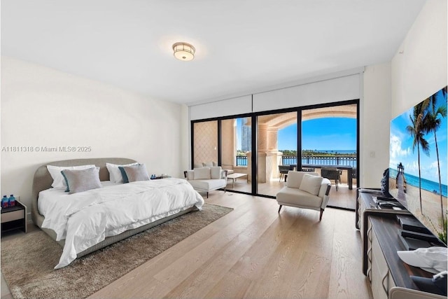 7055 Fisher Island Dr Unit 7055, Miami Beach, FL 33109 - bedroom featuring wood finished floors and access to exterior