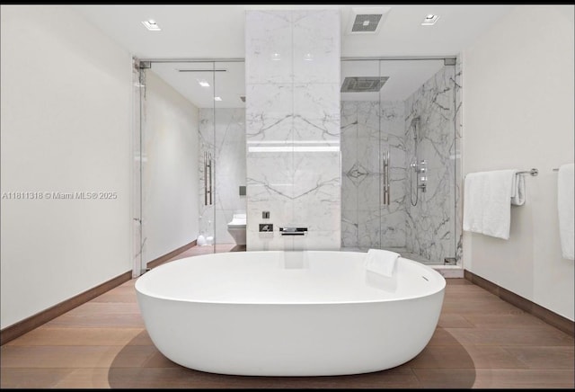 7055 Fisher Island Dr Unit 7055, Miami Beach, FL 33109 - full bath with a freestanding tub, baseboards, a marble finish shower, recessed lighting, and wood finished floors