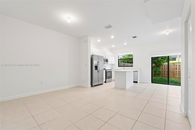 28569 SW 132nd Ct, Homestead, FL 33033 - kitchen with stainless steel appliances, light countertops, white cabinets, baseboards, and light tile patterned flooring
