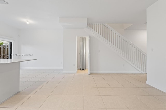 28569 SW 132nd Ct, Homestead, FL 33033 - spare room with stairway, light tile patterned flooring, and baseboards