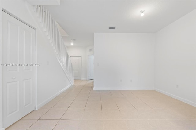 28569 SW 132nd Ct, Homestead, FL 33033 - unfurnished room with light tile patterned flooring, baseboards, and stairs