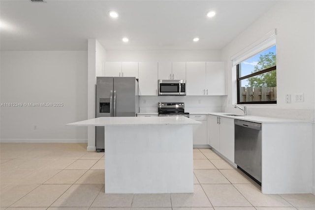 28569 SW 132nd Ct, Homestead, FL 33033 - kitchen with appliances with stainless steel finishes, a kitchen island, light countertops, light tile patterned flooring, and recessed lighting