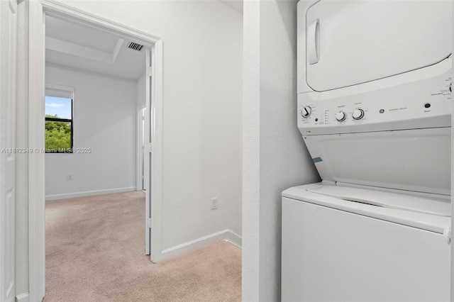 28569 SW 132nd Ct, Homestead, FL 33033 - washroom featuring estacked washer and dryer, light colored carpet, and baseboards