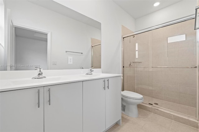 28569 SW 132nd Ct, Homestead, FL 33033 - bathroom with double vanity, a shower stall, toilet, tile patterned floors, and recessed lighting