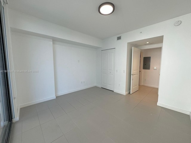 1600 NE 1st Ave Unit 2917, Miami, FL 33132 - unfurnished bedroom featuring electric panel, light tile patterned flooring, a closet, and baseboards