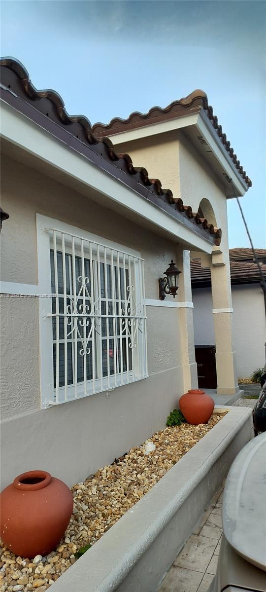 3149 W 68th Pl, Hialeah, FL 33018 - view of side of home with stucco siding