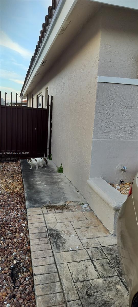 3149 W 68th Pl, Hialeah, FL 33018 - view of property exterior with stucco siding and a tile roof