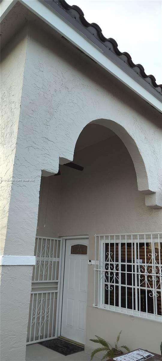 3149 W 68th Pl, Hialeah, FL 33018 - exterior view of stucco siding and arched walkways