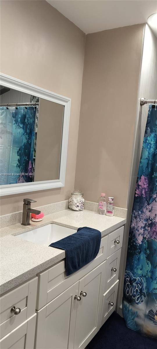 3149 W 68th Pl, Hialeah, FL 33018 - bathroom featuring vanity and a shower with curtain