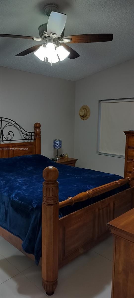 3149 W 68th Pl, Hialeah, FL 33018 - bedroom with a textured ceiling, ceiling fan, and light tile patterned floors