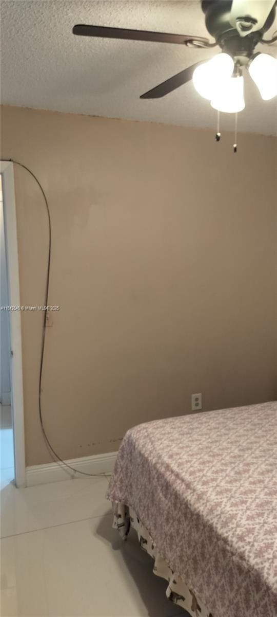 3149 W 68th Pl, Hialeah, FL 33018 - bedroom with ceiling fan and a textured ceiling