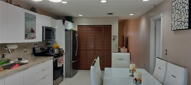 3149 W 68th Pl, Hialeah, FL 33018 - kitchen featuring appliances with stainless steel finishes, modern cabinets, light countertops, a sink, and white cabinetry