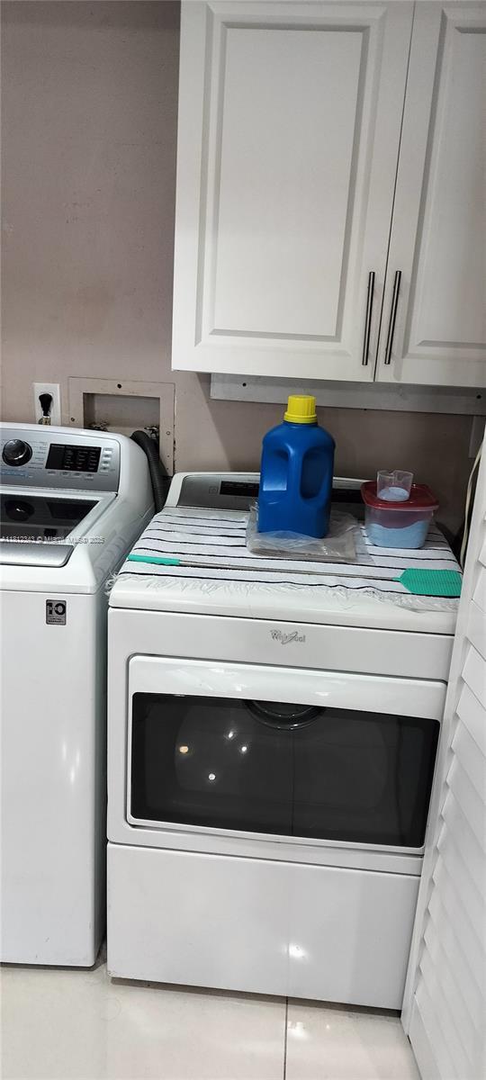 3149 W 68th Pl, Hialeah, FL 33018 - laundry room with washing machine and clothes dryer and cabinet space