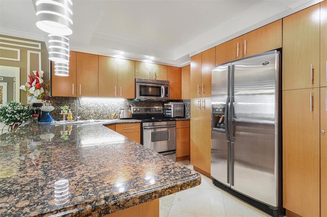 1865 S Ocean Dr Unit 18G, Hallandale Beach, FL 33009 - kitchen with appliances with stainless steel finishes, a sink, tasteful backsplash, a peninsula, and dark stone countertops