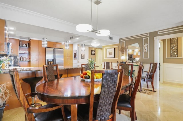 1865 S Ocean Dr Unit 18G, Hallandale Beach, FL 33009 - dining space featuring a decorative wall, crown molding, a wainscoted wall, and a tray ceiling