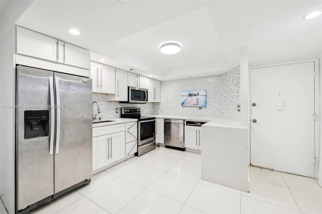 1351 NE Miami Gardens Dr Unit 1111E, Miami, FL 33179 - kitchen with appliances with stainless steel finishes, tasteful backsplash, light countertops, recessed lighting, and a sink