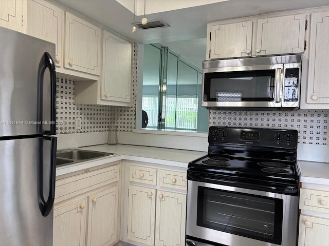 1333 E Hallandale Beach Blvd Unit 134, Hallandale Beach, FL 33009 - kitchen with stainless steel appliances, light countertops, and tasteful backsplash