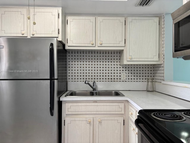 1333 E Hallandale Beach Blvd Unit 134, Hallandale Beach, FL 33009 - kitchen with appliances with stainless steel finishes, a sink, light countertops, and tasteful backsplash