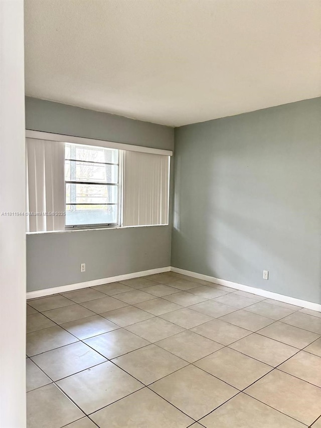 1333 E Hallandale Beach Blvd Unit 134, Hallandale Beach, FL 33009 - tiled spare room featuring baseboards