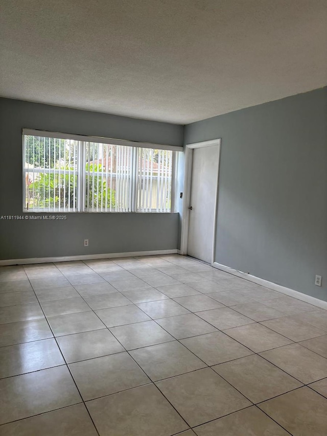 1333 E Hallandale Beach Blvd Unit 134, Hallandale Beach, FL 33009 - tiled spare room with baseboards and a textured ceiling