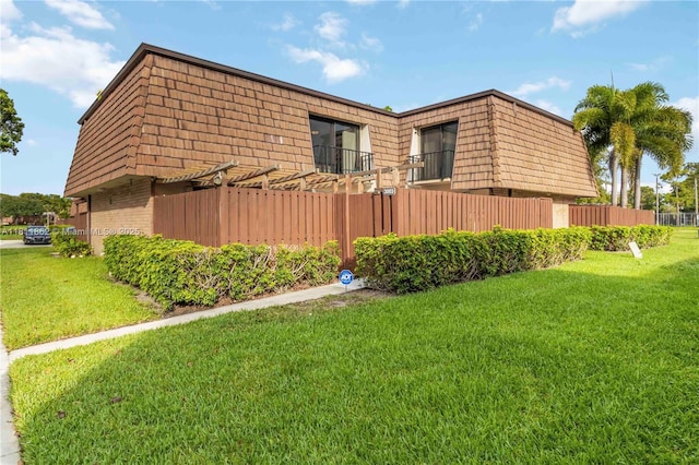 3003 30th Ln, Green Acres, FL 33463 - view of home's exterior featuring mansard roof and brick siding