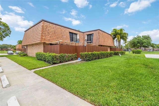 3003 30th Ln, Green Acres, FL 33463 - view of side of property with mansard roof and brick siding