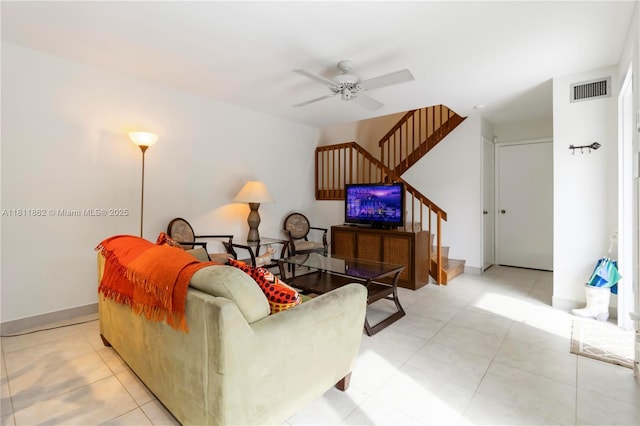 3003 30th Ln, Green Acres, FL 33463 - living room with stairs, a ceiling fan, and light tile patterned flooring