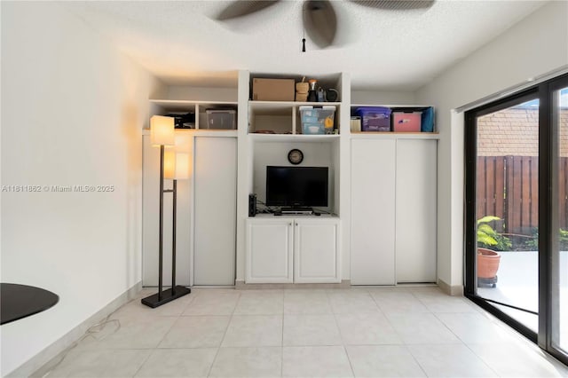 3003 30th Ln, Green Acres, FL 33463 - unfurnished living room featuring ceiling fan, a textured ceiling, and light tile patterned flooring