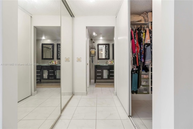 3003 30th Ln, Green Acres, FL 33463 - corridor with a sink and a textured ceiling