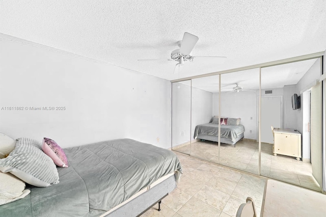 3003 30th Ln, Green Acres, FL 33463 - bedroom featuring a closet, a ceiling fan, and a textured ceiling