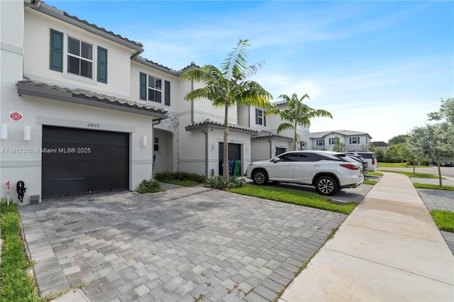 11835 NW 46th St, Coral Springs, FL 33076 - multi unit property with an attached garage, stucco siding, driveway, and a tiled roof