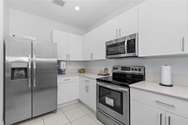 11835 NW 46th St, Coral Springs, FL 33076 - kitchen featuring stainless steel appliances, light countertops, white cabinets, light tile patterned floors, and recessed lighting