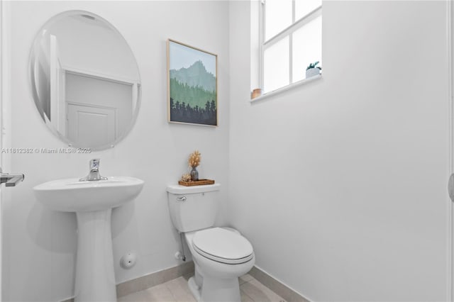 11835 NW 46th St, Coral Springs, FL 33076 - half bathroom featuring toilet, baseboards, tile patterned floors, and a sink