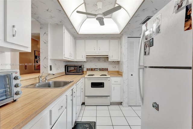 7355 NW 18th St Unit 106, Margate, FL 33063 - kitchen featuring white appliances, a sink, under cabinet range hood, a ceiling fan, and white cabinetry