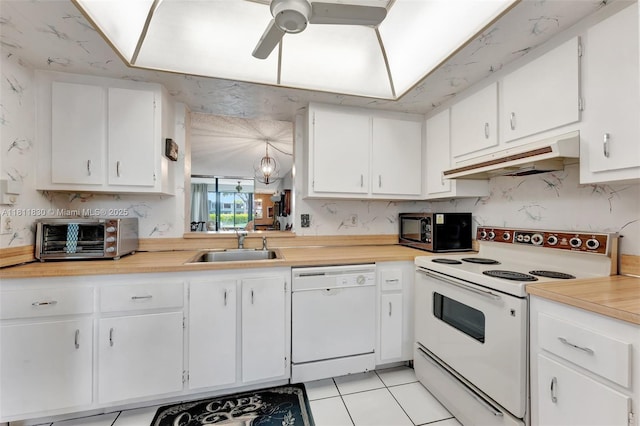 7355 NW 18th St Unit 106, Margate, FL 33063 - kitchen featuring white appliances, under cabinet range hood, a sink, light countertops, and white cabinets