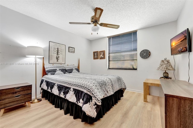 7355 NW 18th St Unit 106, Margate, FL 33063 - bedroom featuring light wood-type flooring, baseboards, a textured ceiling, and ceiling fan
