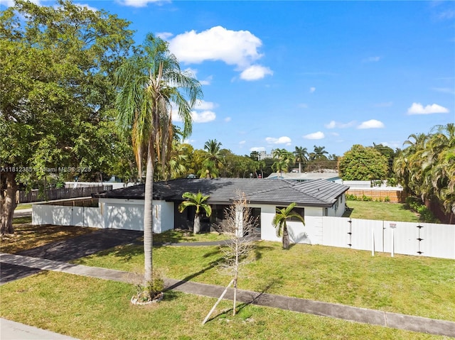 5131 Monroe St, Hollywood, FL 33021 - view of front of property featuring a gate, asphalt driveway, an attached garage, stucco siding, and a tiled roof