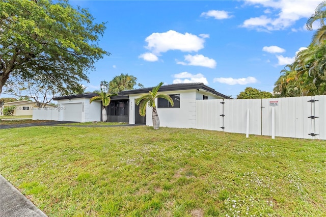5131 Monroe St, Hollywood, FL 33021 - view of front of property with a garage, driveway, a gate, and stucco siding