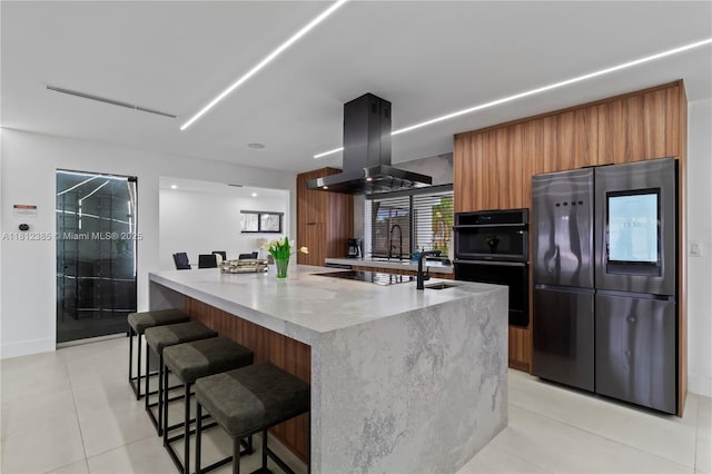 5131 Monroe St, Hollywood, FL 33021 - kitchen featuring black appliances, modern cabinets, island range hood, brown cabinets, and light tile patterned floors